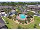 Aerial of townhomes community with a sparkling community pool surrounded by lush landscaping at 5150 Bay Isle Cir, Clearwater, FL 33760