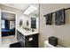 Modern bathroom features a double sink vanity with a white countertop, dark cabinets and a toilet at 5150 Bay Isle Cir, Clearwater, FL 33760