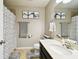 Bathroom featuring shower with a patterned curtain, toilet, framed art, and vanity at 5150 Bay Isle Cir, Clearwater, FL 33760