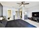 Bedroom with a large bed, ensuite bathroom, walk-in closet, and ceiling fan at 5150 Bay Isle Cir, Clearwater, FL 33760