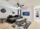 Comfortable bonus room with a sectional sofa, ceiling fan, and decorative rug at 5150 Bay Isle Cir, Clearwater, FL 33760