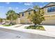Charming townhome exterior featuring a 2-car garage, landscaped front yard, and a clear view on a sunny day at 5150 Bay Isle Cir, Clearwater, FL 33760