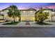 Inviting two-story townhome featuring a two-car garage, complemented by well-maintained landscaping and a clear view at 5150 Bay Isle Cir, Clearwater, FL 33760