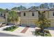 Charming townhome with a two-car garage and well-maintained landscaping, providing a welcoming curb appeal at 5150 Bay Isle Cir, Clearwater, FL 33760