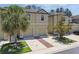 Exterior shot showcasing the home's facade, featuring two garage doors, a well-maintained lawn, and manicured landscaping at 5150 Bay Isle Cir, Clearwater, FL 33760
