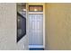 Stylish front door with sidelight and transom window, showcasing a welcoming entrance to the home at 5150 Bay Isle Cir, Clearwater, FL 33760