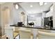 Bright kitchen featuring granite counters, stainless steel appliances, a dining area, and breakfast bar at 5150 Bay Isle Cir, Clearwater, FL 33760