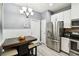 Charming eat-in kitchen featuring stainless steel appliances, a dining table, and ample storage, perfect for Gathering meals at 5150 Bay Isle Cir, Clearwater, FL 33760