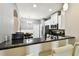 Bright kitchen featuring granite counters, stainless steel appliances, breakfast bar, and a dining area at 5150 Bay Isle Cir, Clearwater, FL 33760