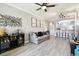 A spacious living room with a gray sofa, modern art, and a bar cabinet, creating an inviting atmosphere at 5150 Bay Isle Cir, Clearwater, FL 33760
