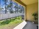 A covered patio includes an AC unit, green grass, a privacy fence, and palm trees, adding comfort and seclusion at 5150 Bay Isle Cir, Clearwater, FL 33760
