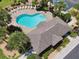 Aerial shot of a sparkling community pool surrounded by lush landscaping and lounge chairs at 5150 Bay Isle Cir, Clearwater, FL 33760