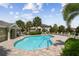 Community pool surrounded by lounge chairs, landscaping, and community homes at 5150 Bay Isle Cir, Clearwater, FL 33760