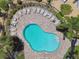 Overhead view of a community pool featuring an ample deck with lounge chairs and landscaping at 5150 Bay Isle Cir, Clearwater, FL 33760