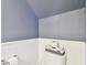 Stylish powder room with white wainscoting, a toilet, and blue-gray paint at 5150 Bay Isle Cir, Clearwater, FL 33760