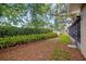 View of backyard with lush landscaping, privacy fence, and screened in patio at 5600 Bay Pines Lakes Blvd, St Petersburg, FL 33708
