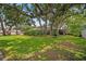 Large backyard with mature trees providing ample shade, and a swing at 5600 Bay Pines Lakes Blvd, St Petersburg, FL 33708