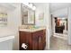 Bathroom features a dark wood vanity with granite countertops and access to the kitchen at 5600 Bay Pines Lakes Blvd, St Petersburg, FL 33708