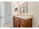 Bathroom featuring a wooden vanity with a light countertop, and a new framed mirror at 5600 Bay Pines Lakes Blvd, St Petersburg, FL 33708