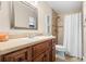 Bathroom with stylish vanity, quartz countertop, shower with tile and a new shower curtain at 5600 Bay Pines Lakes Blvd, St Petersburg, FL 33708