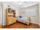 Cozy bedroom featuring a wood bed frame, matching dresser with shelving, and hardwood floors at 5600 Bay Pines Lakes Blvd, St Petersburg, FL 33708
