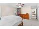 Bright bedroom showcasing neutral carpet, a ceiling fan, and a dresser for ample storage at 5600 Bay Pines Lakes Blvd, St Petersburg, FL 33708