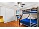room with wood floors, bunkbeds, and large closets for organized storage at 5600 Bay Pines Lakes Blvd, St Petersburg, FL 33708