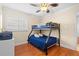 room with wood floors, bunkbeds, and a ceiling fan for comfortable living at 5600 Bay Pines Lakes Blvd, St Petersburg, FL 33708
