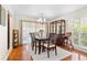 Charming dining area with a modern chandelier and sliding door to the backyard at 5600 Bay Pines Lakes Blvd, St Petersburg, FL 33708