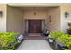 Close-up of the home's front door entrance featuring double doors, sidelights, and brick flooring at 5600 Bay Pines Lakes Blvd, St Petersburg, FL 33708