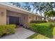 Inviting front entrance featuring double doors, decorative plants, and exterior lighting at 5600 Bay Pines Lakes Blvd, St Petersburg, FL 33708