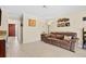 Comfortable living room space featuring tile floors, brown leather sofa, and decorative movie-themed wall decor at 5600 Bay Pines Lakes Blvd, St Petersburg, FL 33708