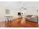 Spacious living room area with hardwood floors and a view of the dining area at 5600 Bay Pines Lakes Blvd, St Petersburg, FL 33708