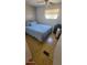 A simple bedroom with parquet flooring, a comfortable queen-sized bed, and natural light at 585 Sky Harbor Dr # 327, Clearwater, FL 33759