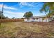 Spacious backyard featuring lush grass and a sturdy wood fence at 5911 63Rd N Ter, Pinellas Park, FL 33781
