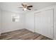 Bedroom features wood-look flooring, a ceiling fan, and a double-door closet at 5911 63Rd N Ter, Pinellas Park, FL 33781
