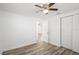 Bedroom features ceiling fan and closet, complemented by neutral wall and flooring at 5911 63Rd N Ter, Pinellas Park, FL 33781