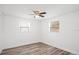 Bedroom with hardwood floors, ceiling fan, and white walls at 5911 63Rd N Ter, Pinellas Park, FL 33781