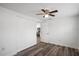 A bedroom with wood-look flooring features a door to the kitchen at 5911 63Rd N Ter, Pinellas Park, FL 33781