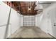 Clean and organized garage space with an open ceiling and white walls at 5911 63Rd N Ter, Pinellas Park, FL 33781
