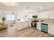 Bright, updated kitchen featuring white cabinetry, stainless steel appliances, stone countertops, and modern pendant lighting at 5911 63Rd N Ter, Pinellas Park, FL 33781