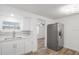 Galley kitchen with stainless refrigerator and pass through to another room at 5911 63Rd N Ter, Pinellas Park, FL 33781