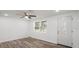 An open living area with wood-look flooring, a ceiling fan and a glass decorated front door at 5911 63Rd N Ter, Pinellas Park, FL 33781