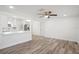Open concept living and dining area showing wood-look flooring and white walls at 5911 63Rd N Ter, Pinellas Park, FL 33781