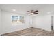 A naturally lit living area features wood-look flooring, a ceiling fan, and a view to the yard at 5911 63Rd N Ter, Pinellas Park, FL 33781
