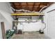 Utility room with water heater, sink, and shelving, offering practical storage solutions at 5911 63Rd N Ter, Pinellas Park, FL 33781