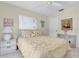 Comfortable bedroom with neutral colors, a ceiling fan, and a quaint white dresser for added storage at 601 N Hercules Ave # 101, Clearwater, FL 33765