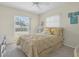 Cozy bedroom featuring a large window, ceiling fan, and beach themed decor on the walls at 601 N Hercules Ave # 101, Clearwater, FL 33765