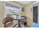 Bright breakfast nook with wicker chairs, a small table, and a large window overlooking the yard at 601 N Hercules Ave # 101, Clearwater, FL 33765