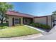 Charming one-story home featuring a red tile roof, green lawn, and well-maintained landscaping at 601 N Hercules Ave # 101, Clearwater, FL 33765